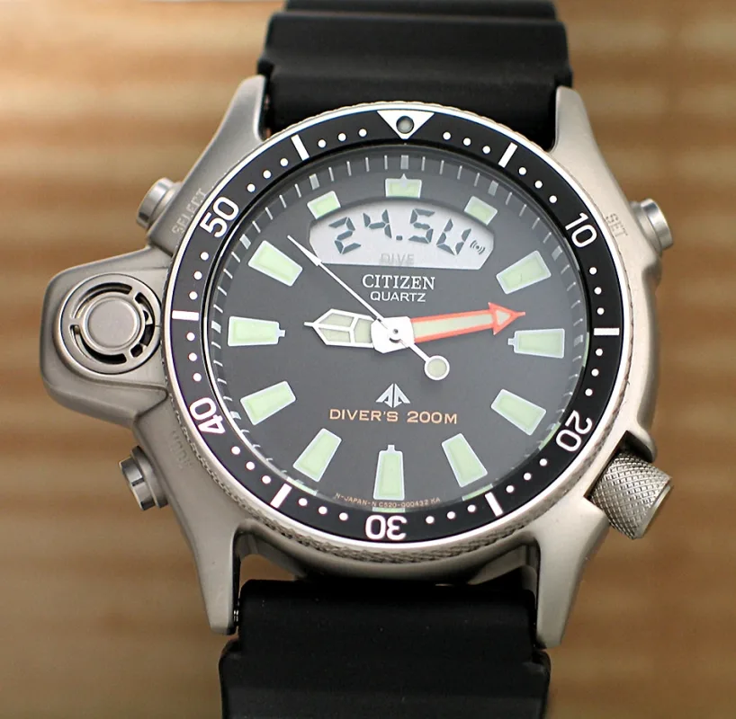 CITIZEN JP2000-08E with black dial, orange minute hand, depth display and black strap