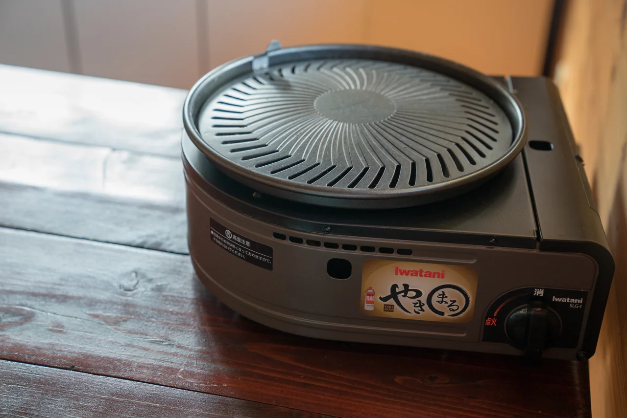 Original bronze and black Iwatani Yakimaru grill, with SLG-1 visibly printed beside the ignition control