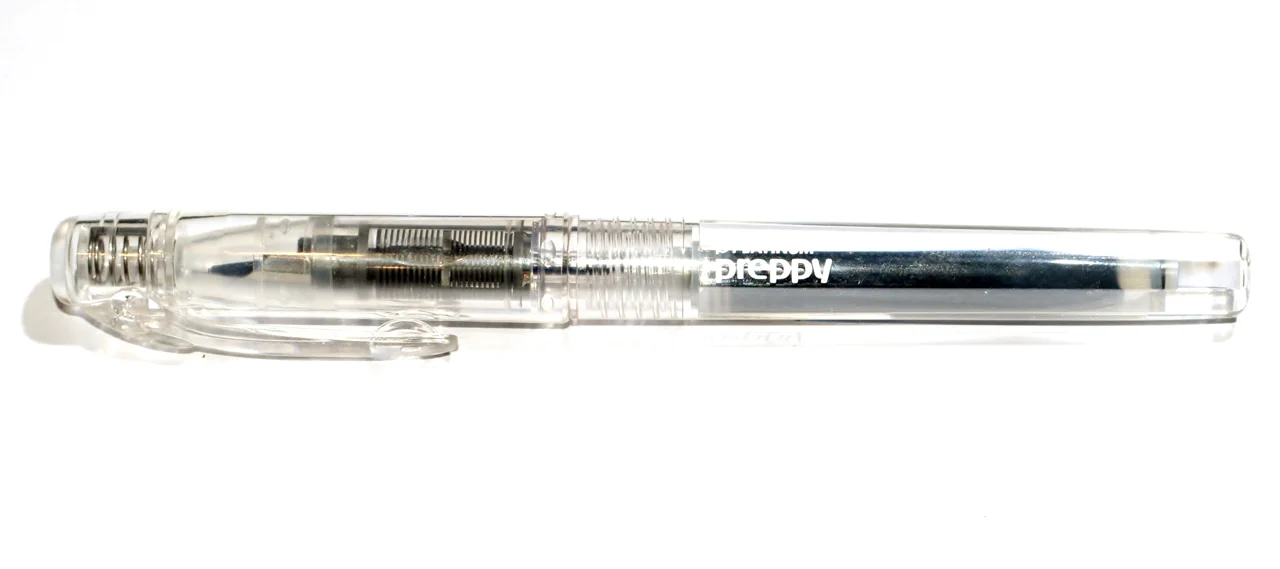 Transparent Platinum Preppy Crystal fine 03 fountain pen, capped, with a black cartridge visible inside; seller postcard not pictured