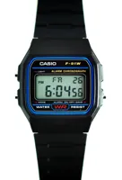 Black Casio F-91W-1 digital watch with blue face border, photographed in 2013