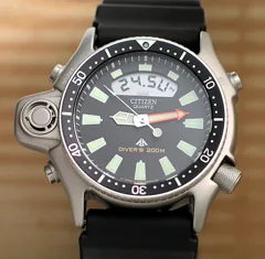 CITIZEN JP2000-08E with black dial, orange minute hand, depth display and black strap